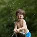 2-year-old Liam Taton of Allen Park squints his eyes and smiles as he plays with a water-spraying frog statue Sunday afternoon during Huron River Day at Gallup Park.Jeffrey Smith | AnnArbor.com